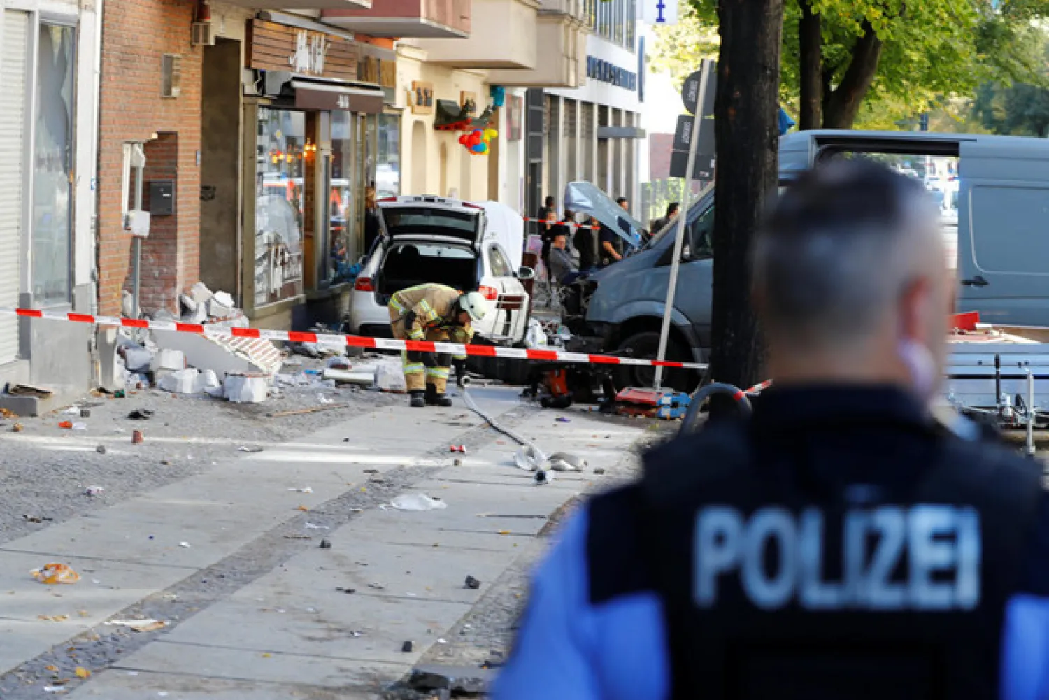 Police around the area where a man drove a car into a cafe in the Charlottenburg district of Berlin, Germany, October 5, 2018. (Reuters)

