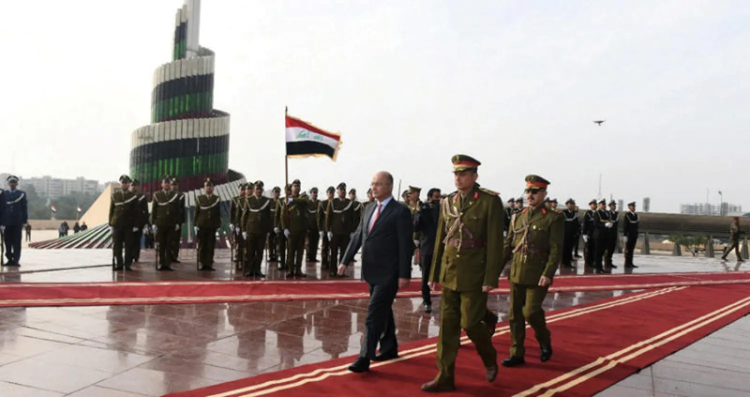 الرئيس العراقي برهم صالح يحضر استعراضاً في ذكرى تأسيس الجيش في بغداد أمس (رويترز)