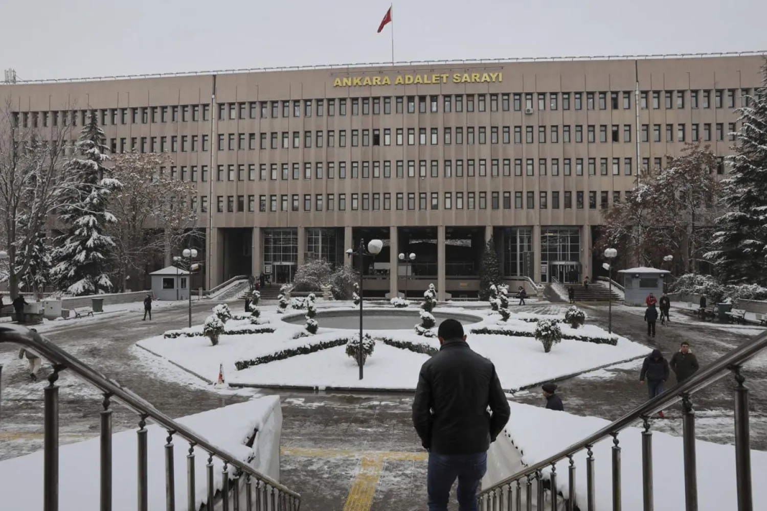 A man walks towards a court in Ankara, on Tuesday, January 8, 2019, where a trial has opened against 28 people accused of involvement in the 2016 killing of Russia's ambassador to Turkey. (AP)