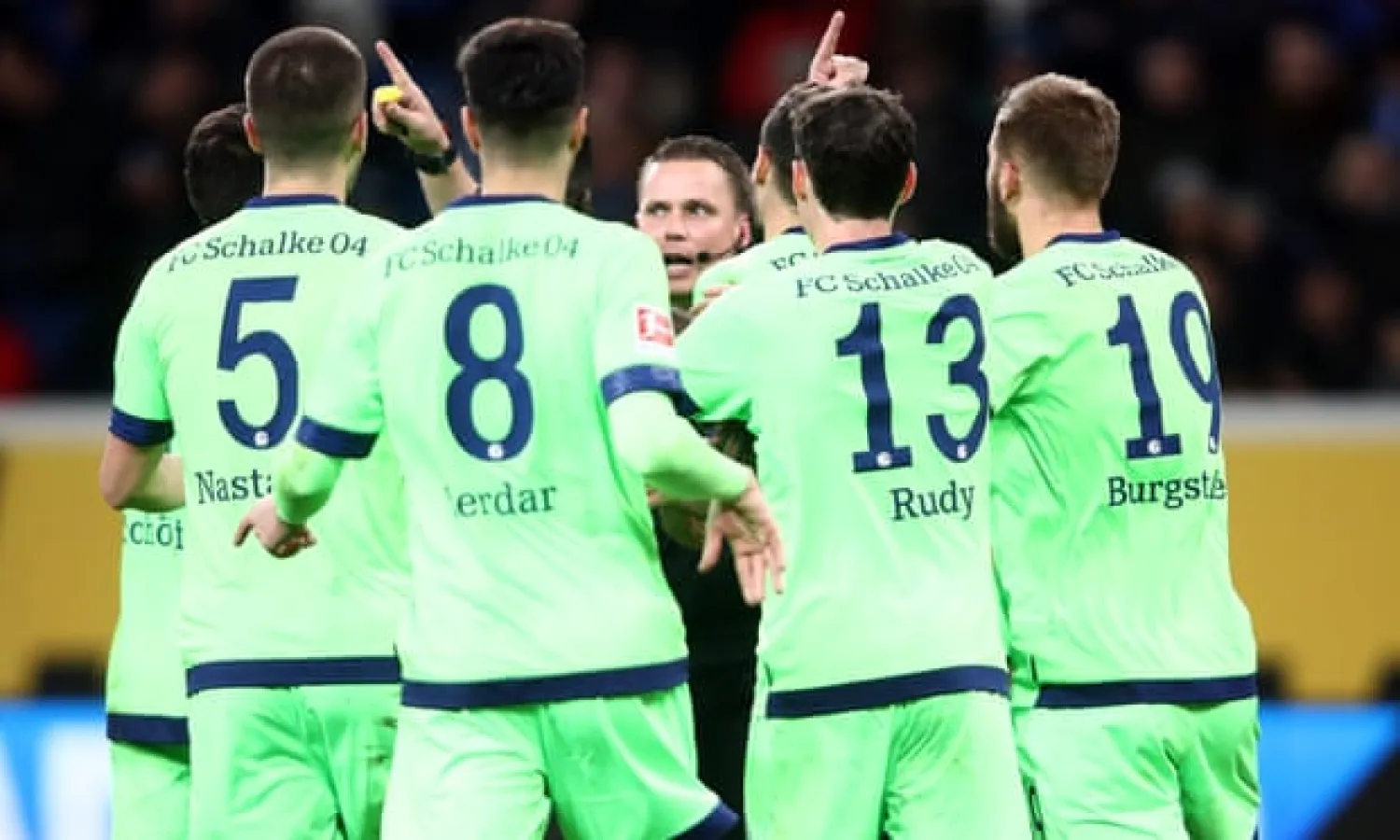  Referee Robert Kampka is surrounded by Schalke players of Schalke after awarding Hoffenheim a penalty. Photograph: Alex Grimm/Bongarts/Getty Images
