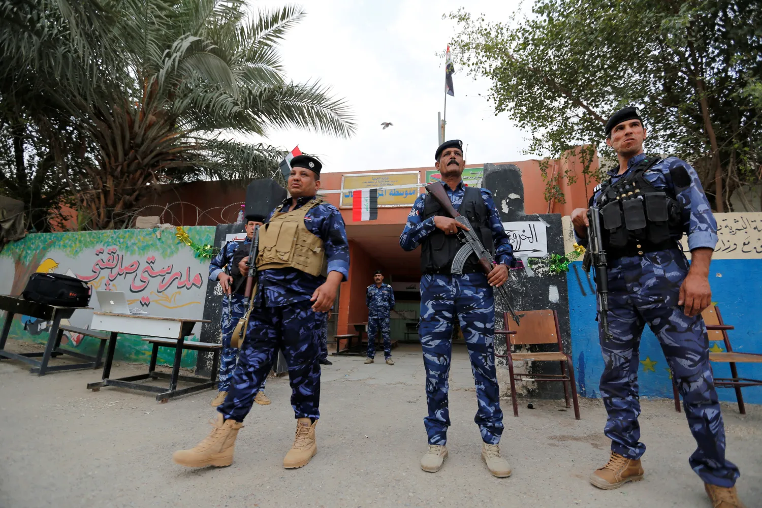 Iraqi security forces stand guard outside a polling station during the parliamentary election in the Sadr city district of Baghdad, Iraq May 12, 2018. (Reuters)