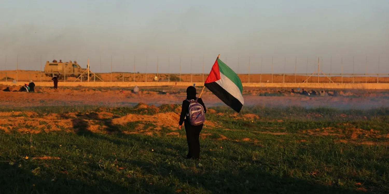 A Palestinian girl seen with a flag during protests on the Gaza-Israel wall east of Khan Yunis on Jan. 4, 2019. (Getty Images)