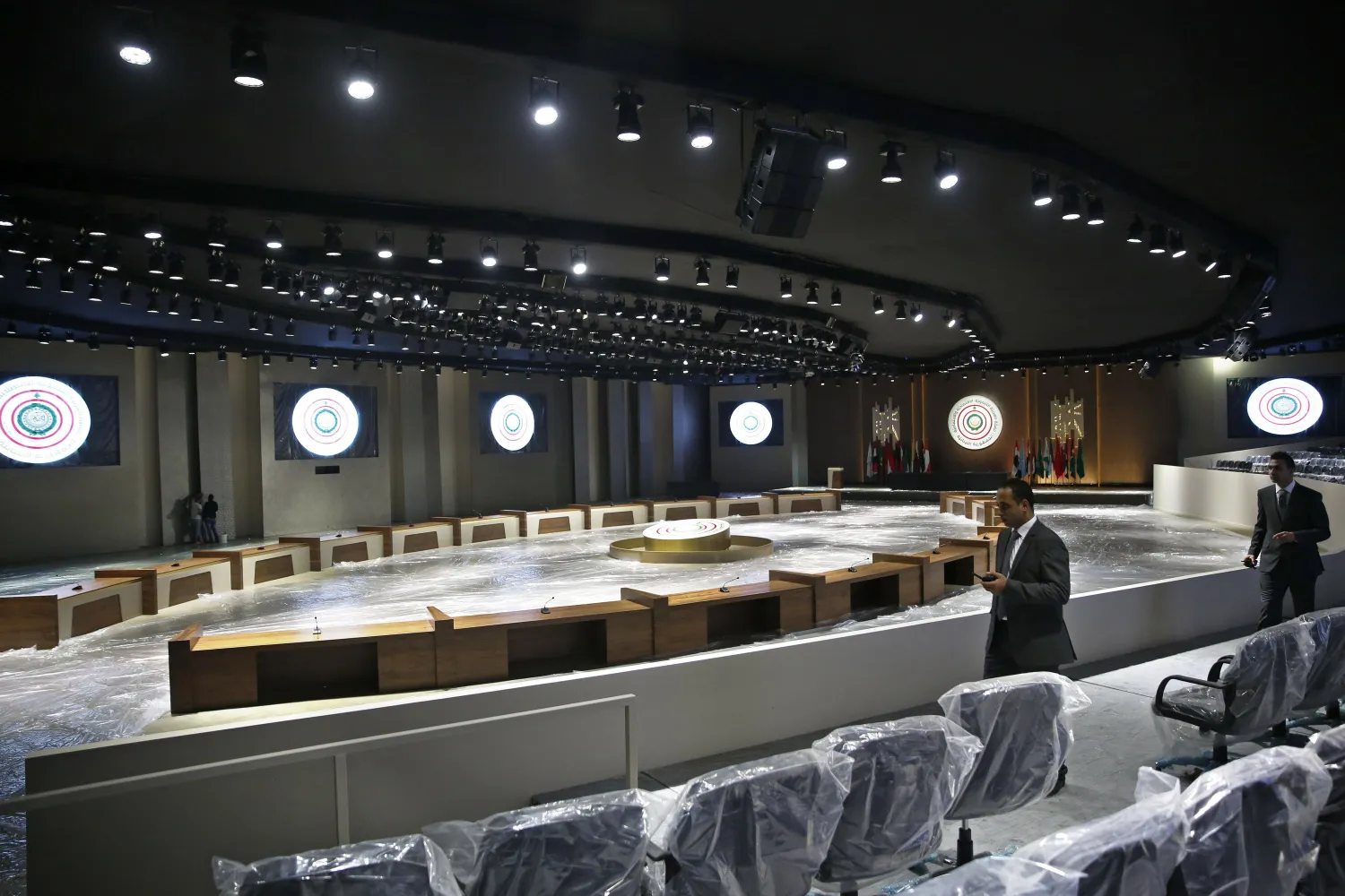 In this Monday, Jan. 14, 2019 photo, Lebanese security officers check a hall where an Arab economic development summit will be held, in Beirut, Lebanon. (AP Photo/Hussein Malla)