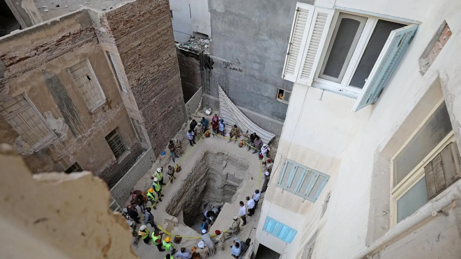 Workers open a coffin containing three mummies discovered in Alexandria, Egypt July 19, 2018. (Reuters)