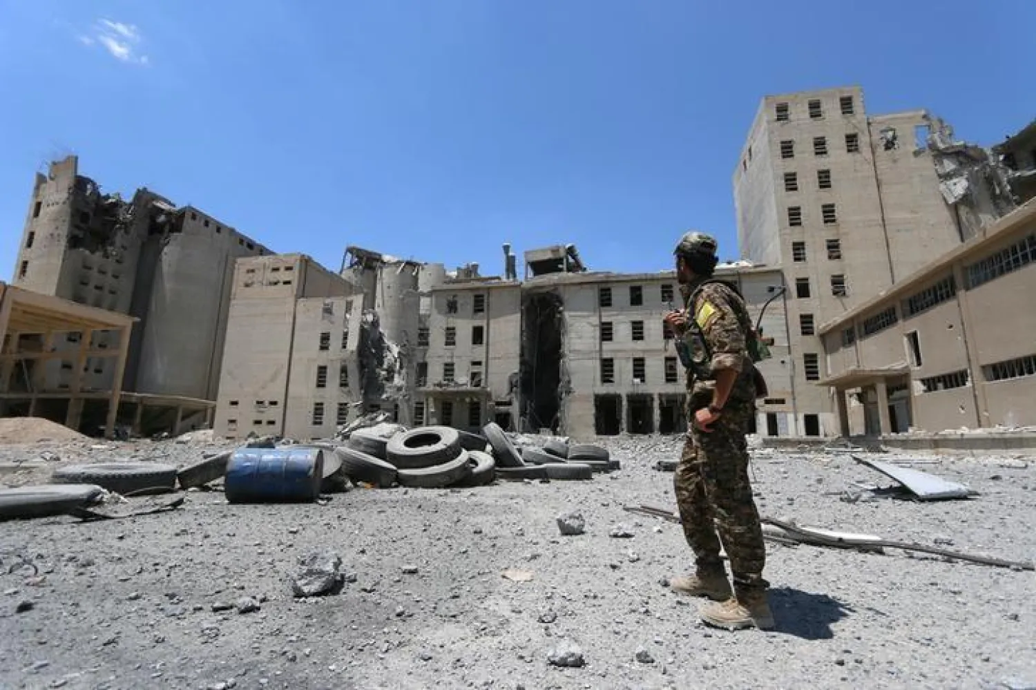 A Syria Democratic Forces (SDF) fighter walks in the silos and mills of Manbij after the SDF took control of it, in Aleppo Governorate, Syria, July 1, 2016. REUTERS/Rodi Said

