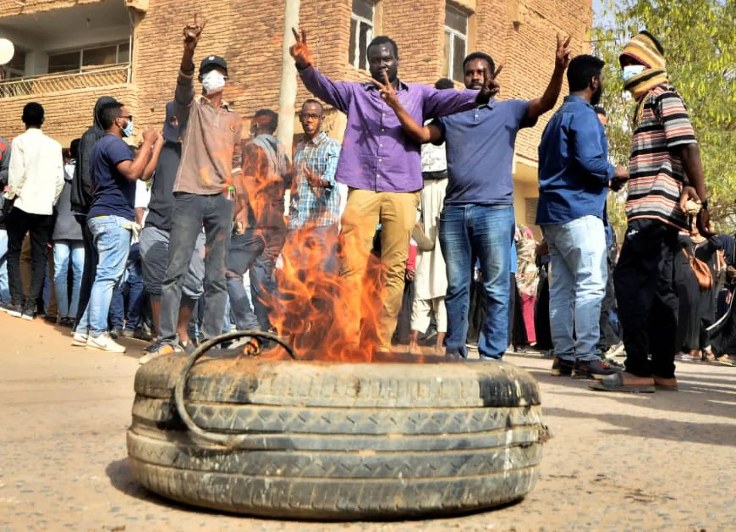 Sudanese demonstrators burn a tire as they participate in anti-government protests in Khartoum Thursday. Reuters
