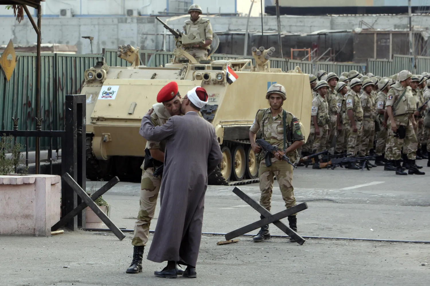  A religious scholar kisses an army officer as a greeting in Cairo July 9, 2013. Reuters/Asmaa Waguih 

