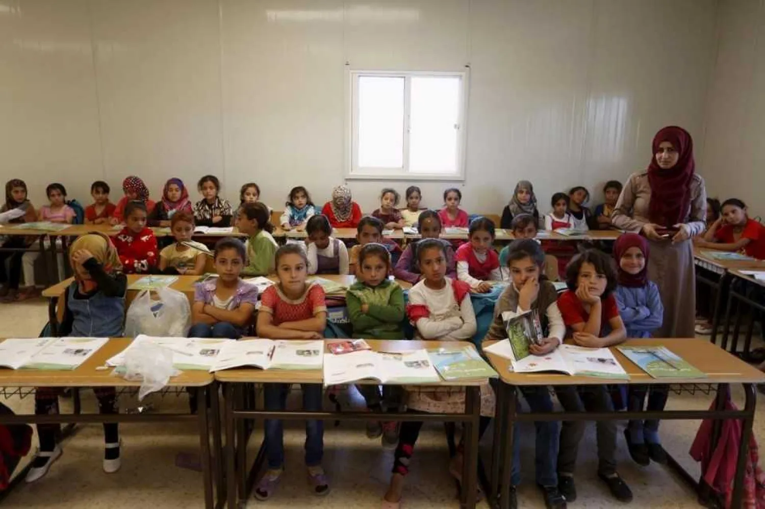 Al Zaatari refugee camp, Jordan Teacher Hanan Anzi with Syrian refugee students at a UNICEF school. Muhammad Hamed / Reuters