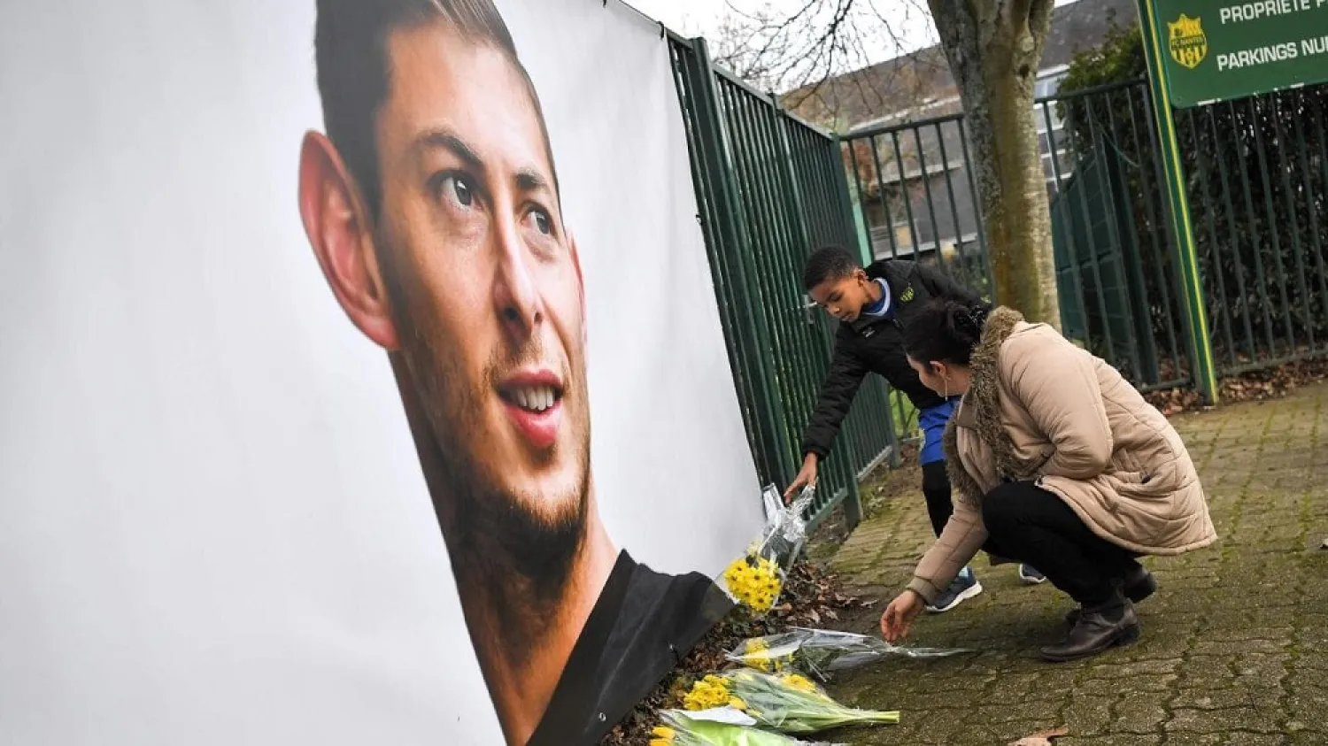 People put flowers in front of the entrance of the FC Nantes football club training center La Joneliere in La Chapelle-sur-Erdre. (AFP)
