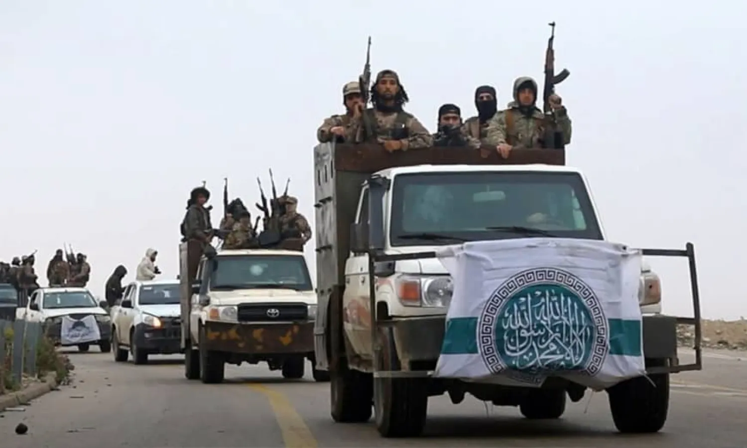 This photo released Dec. 4, 2018, by the al-Qaida-affiliated Ibaa News Agency, shows al-Qaida-linked fighters driving their vehicles during a military drill in northern Syria. (Ibaa News Agency, via AP)