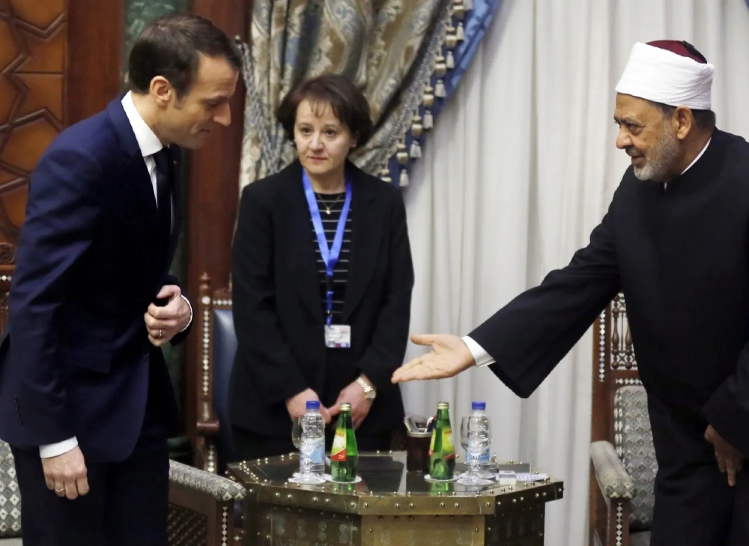 French President Emmanuel Macron (left) is received by Ahmed Al-Tayeb, grand imam of Al-Azhar, during his visit to the Azhar headquarters in Cairo, Tuesday. (AFP)