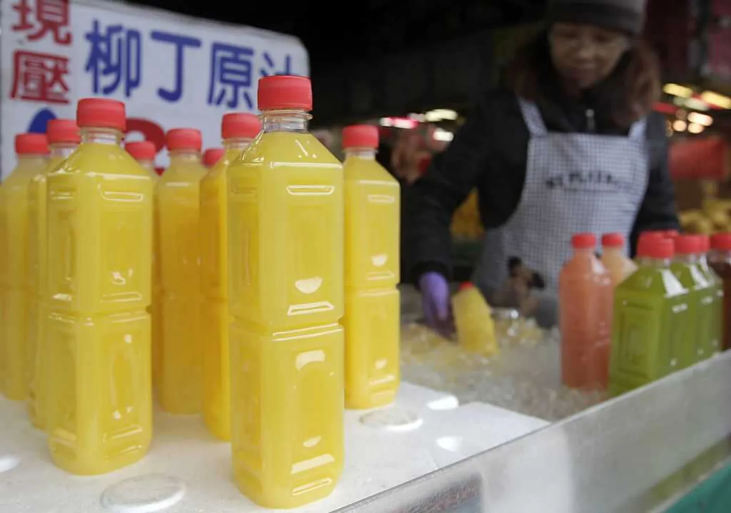 Bottled juice are arranged at a fruit stall in a traditional market in Taipei. Photo: Reuters