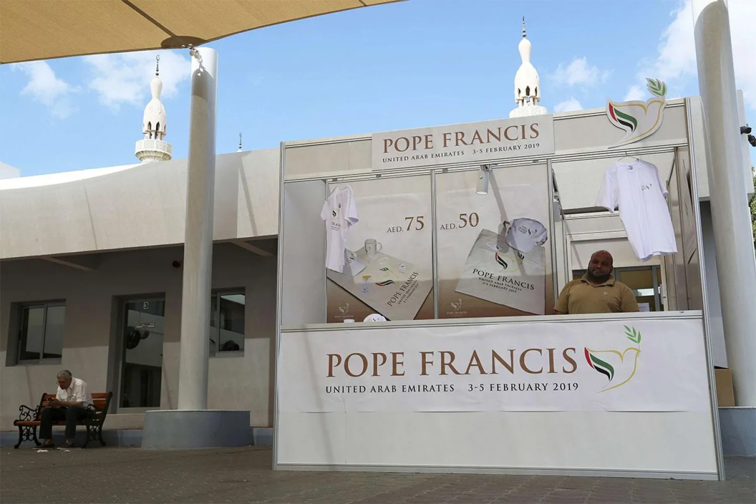 In this Jan. 20, 2019, file photo, a man sells memorabilia for Pope Francis' upcoming trip to the United Arab Emirates at St. Mary's Catholic Church in Dubai, United Arab Emirates. (AP Photo/Jon Gambrell, File)