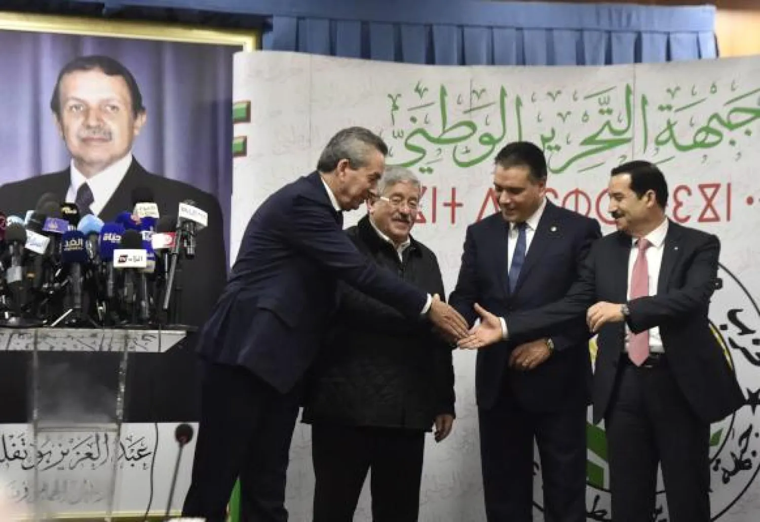 Algerian Ministers and representatives of the president-candidate Abdelaziz Bouteflika (L to R) Amara Benyounes, Ahmed Ouyahia, Mouad Bouchareb, and Amar Ghoul shake hands after a political meeting in the capital Algiers on February 2, 2019. - 