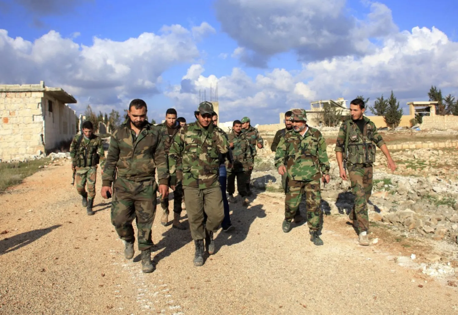 Regime forces walk in al-Mallah Farms after regaining control of the area in north of Aleppo December 15, 2014. REUTERS/George Ourfalian