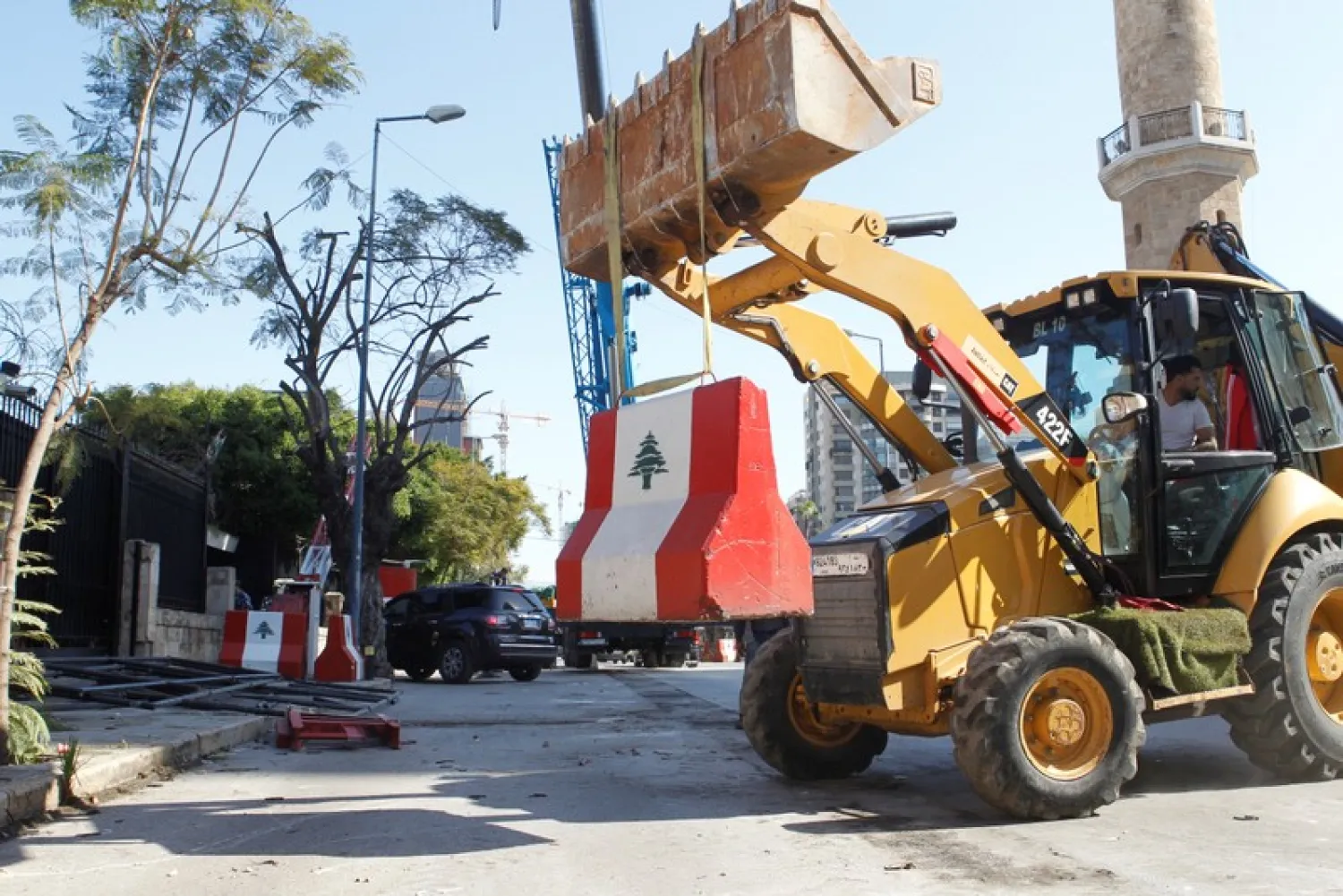 A bulldozer works to remove cement barrier in front of the Interior Ministry in Beirut, Lebanon February 5, 2019. REUTERS/Mohamed Azakir