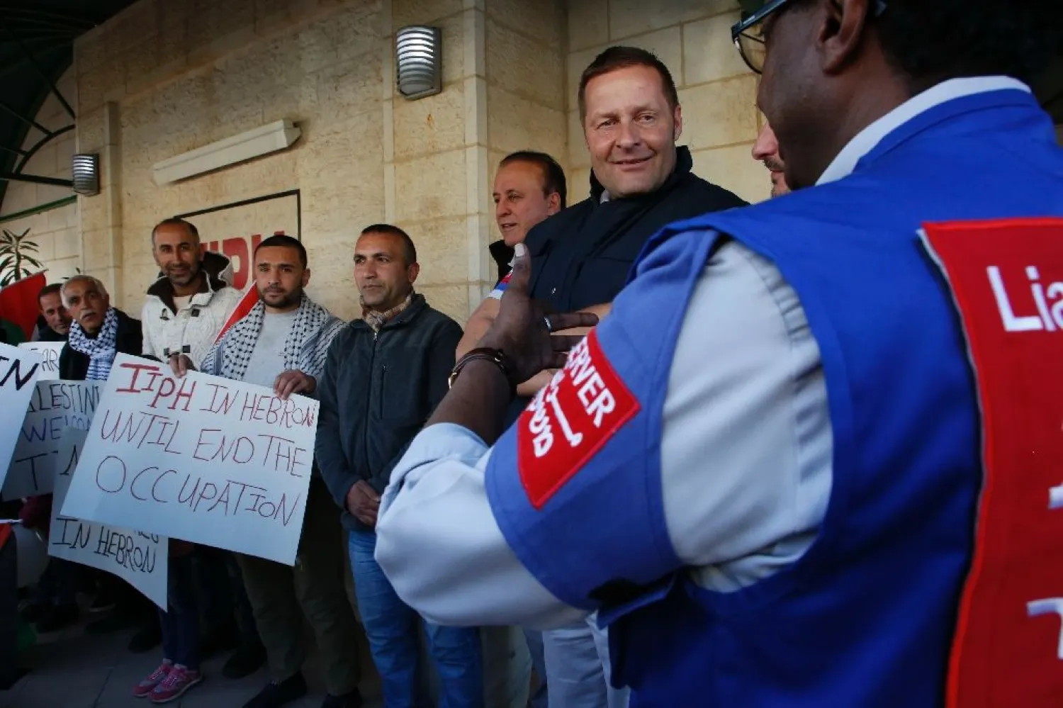 Members of the Temporary International Presence in Hebron (TIPH), pictured here with activists in January 2019, established the group following a massacre of Palestinians in 1994 | AFP