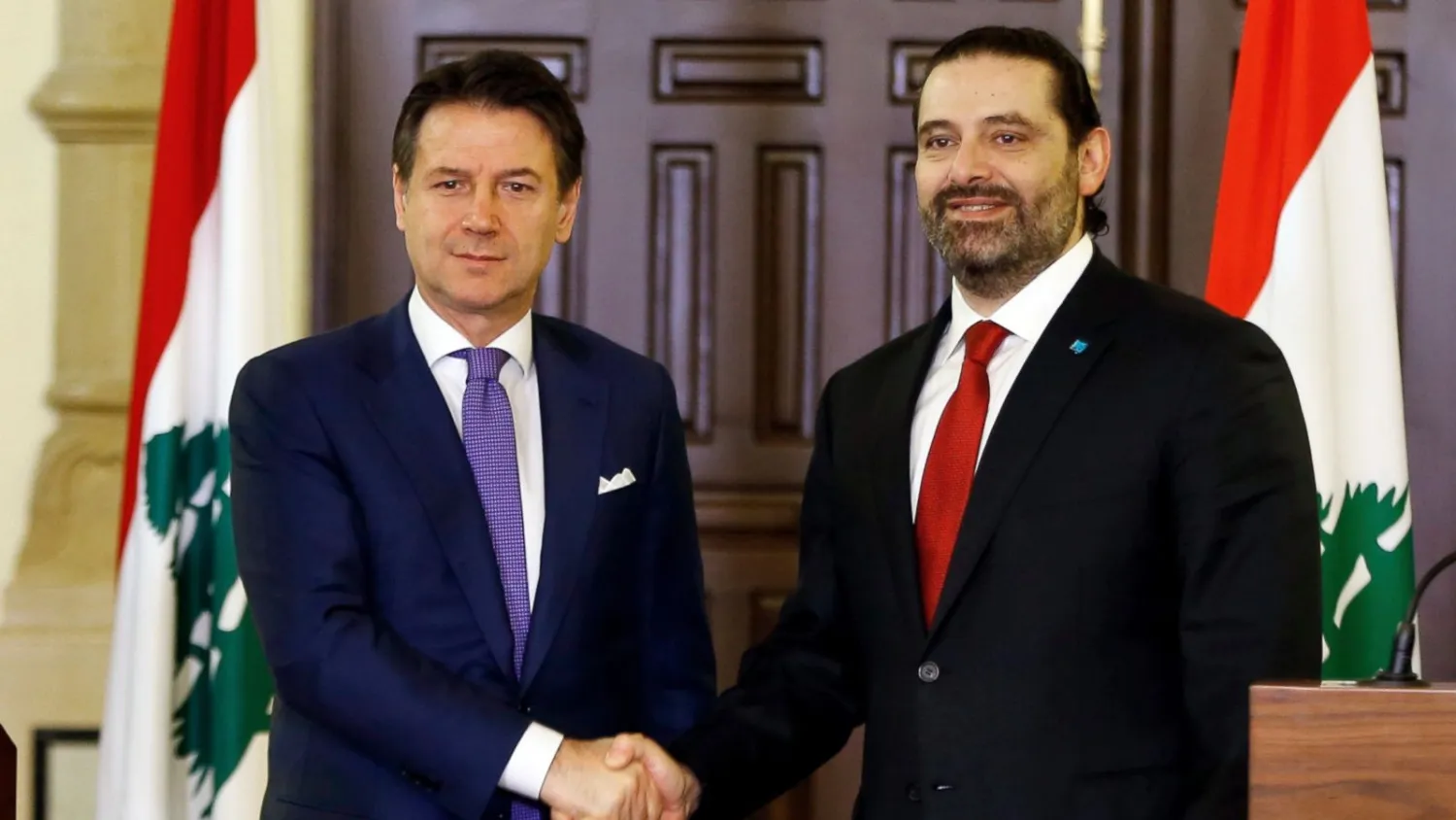 Italian Prime Minister Giuseppe Conte, left, shakes hands with his Lebanese counterpart Saad Hariri after a joint press conference, at the Government House in Beirut, Lebanon, Thursday, Feb. 7, 2019. (AP Photo/Bilal Hussein)