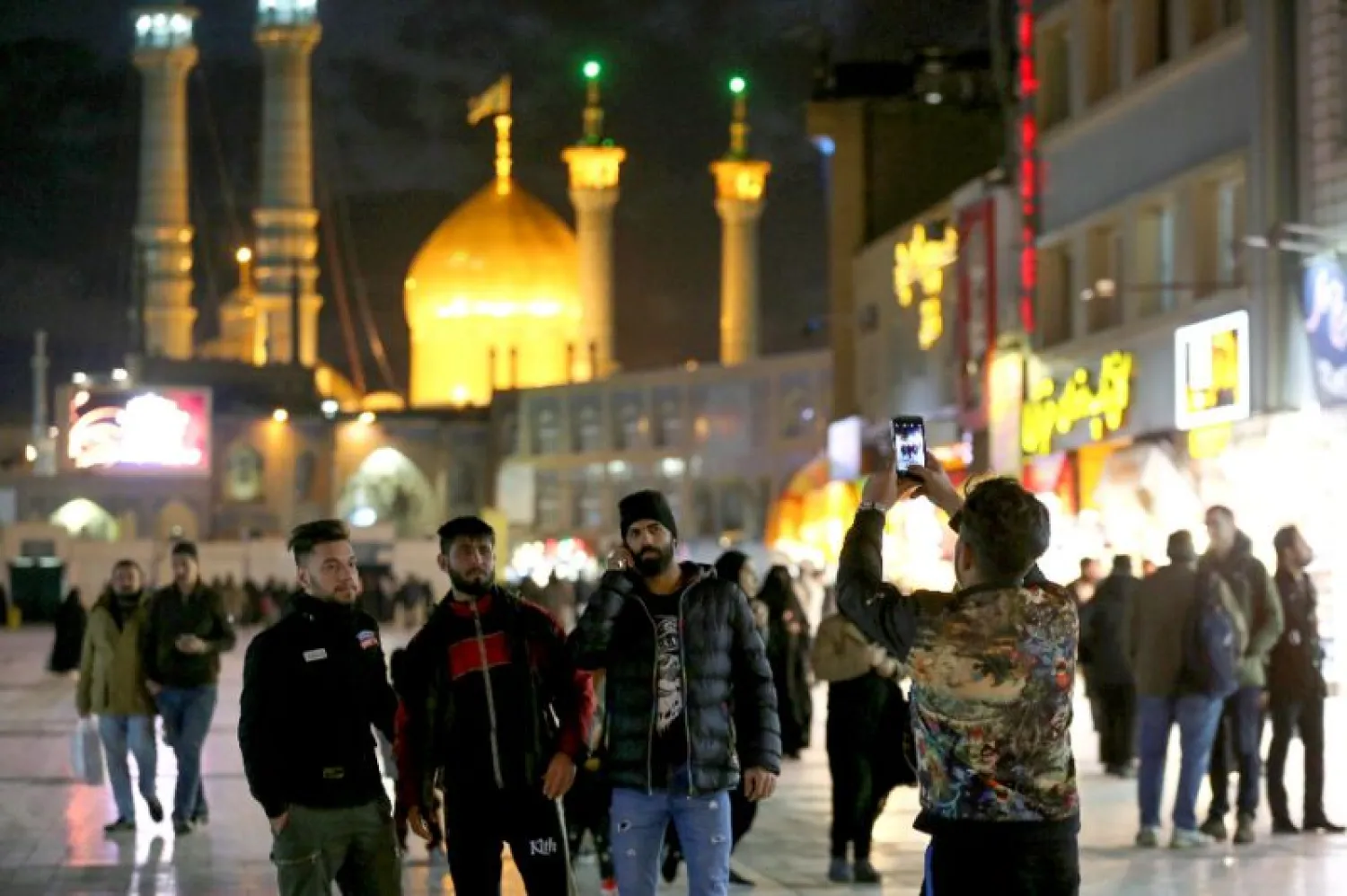 Visitors take a picture near Massoumeh shrine in Iran's holy city of Qom | AFP