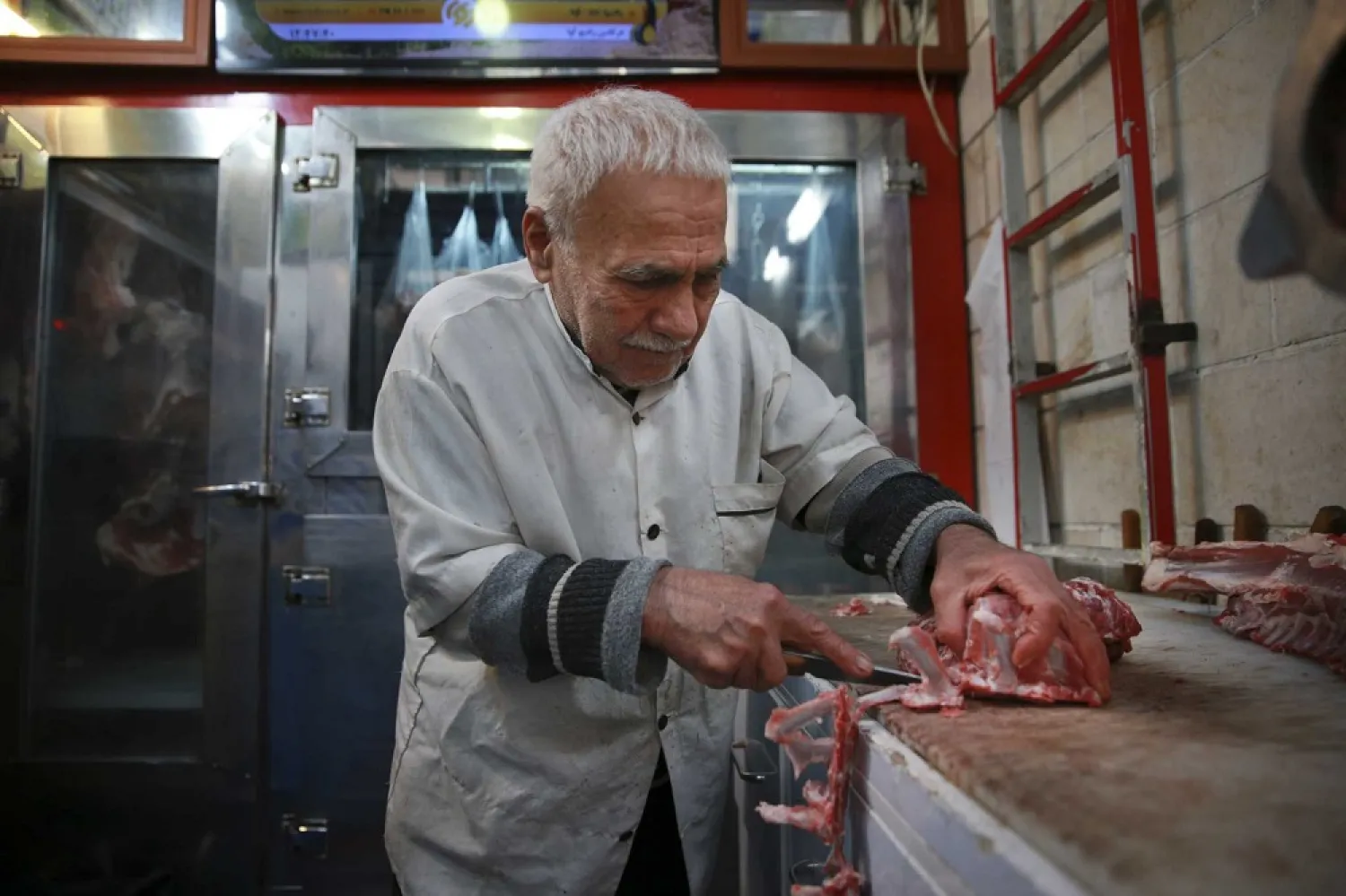 In this Thursday, February 7, 2019 photo, butcher Ghasem Olfatian works at his shop in Tehran, Iran. (AP)