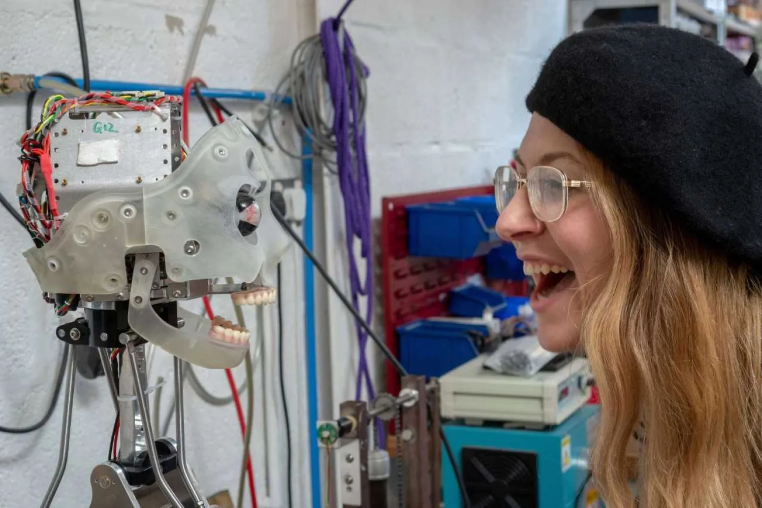 A woman interacts with Ai-Da at the offices of robotics company Engineered Arts in Falmouth. Reuters/MATTHEW STOCK