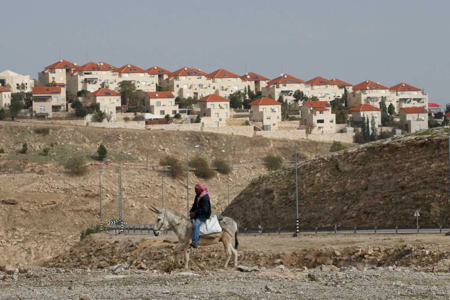 A Palestinian man rides a donkey near the Israeli settlement of Maale Edumim, in the occupied West Bank, December 28, 2016. REUTERS/Baz Ratner/File photo