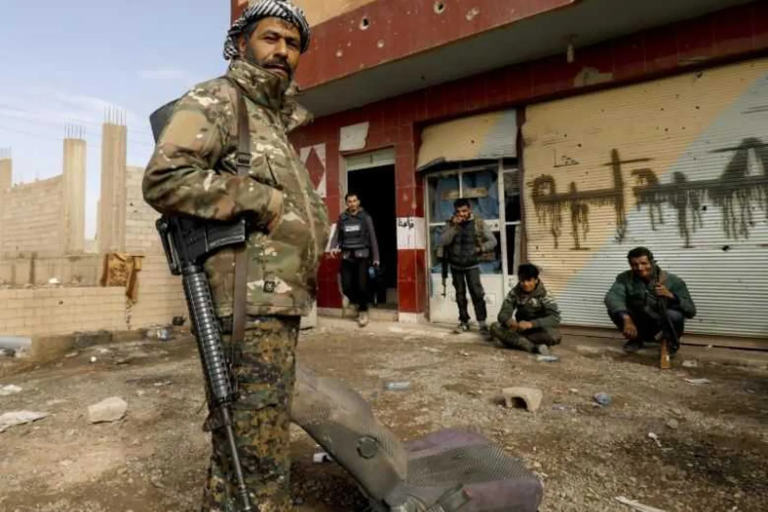 Syrian Democratic Forces fighters taking a break during an operation to expel ISIS militants from Baghouz in Syria's Deir Ezzor province, on Feb 16, 2019. (AFP)