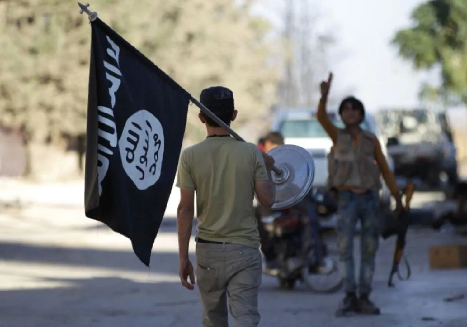 A rebel fighter takes away a flag that belonged to ISIS militants in Akhtarin village, in northern Aleppo Governorate, Syria, October 7, 2016. (photo credit: REUTERS)
