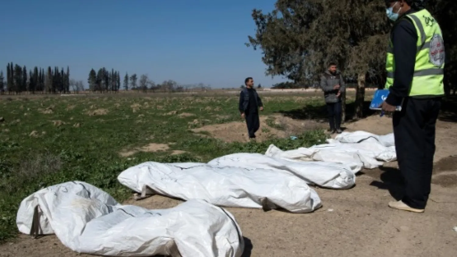 Raqqa civil defense workers survey bodies excavated from a mass grave in the northern Syrian city. AFP