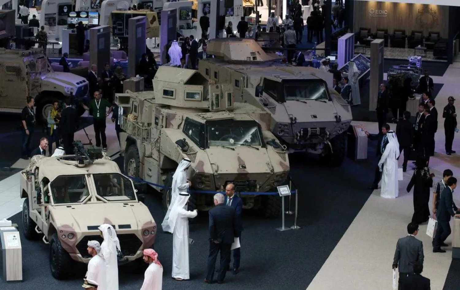 Visitors look at vehicles on display during the International Defense Exhibition and Conference (IDEX) in Abu Dhabi, United Arab Emirates February 19, 2017. REUTERS/Stringer