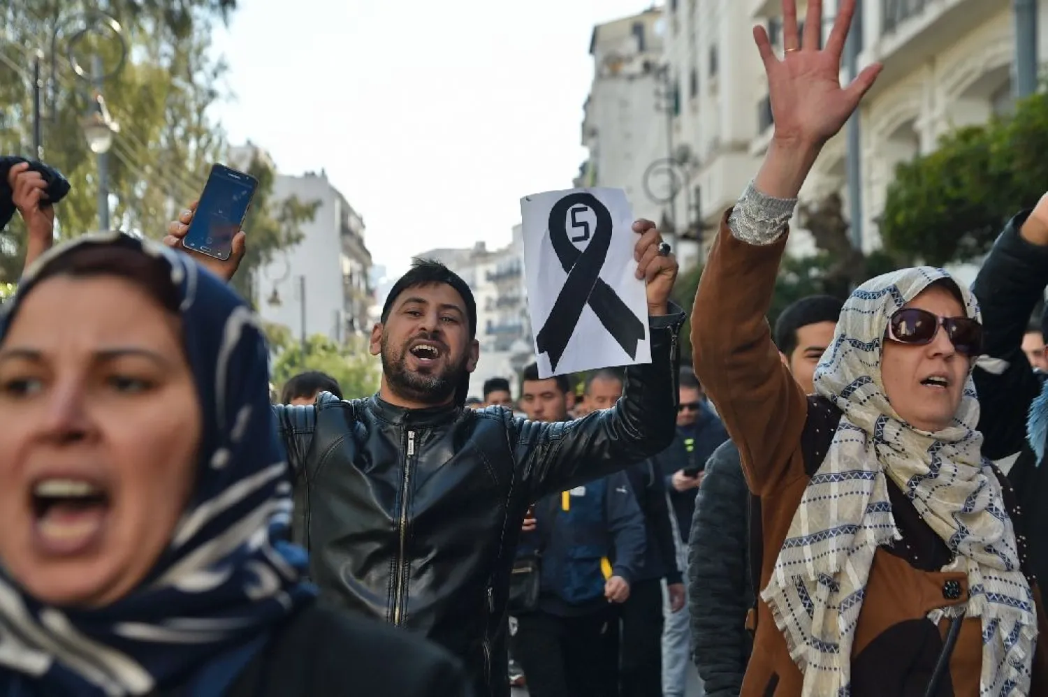 Young demonstrators take part in a protest against President Bouteflika's candidacy for a fifth term in Algiers. (AFP)