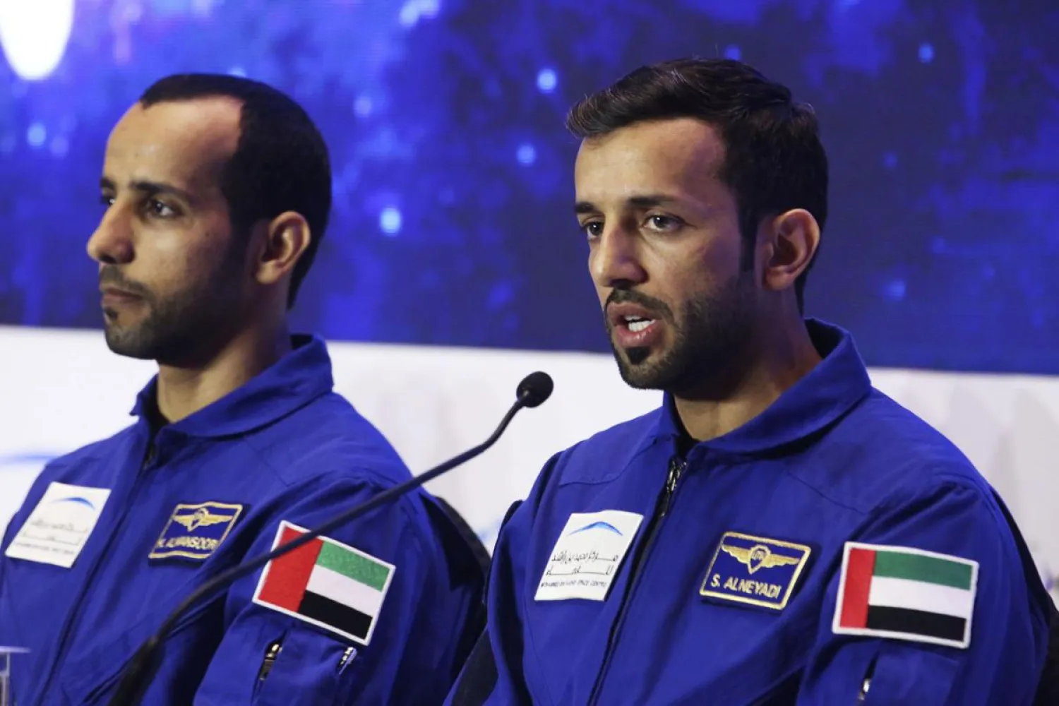 Emirati astronaut Sultan al-Neyadi, right, and astronaut Hazza al-Mansoori, second from right, brief journalists in Dubai, United Arab Emirates, Monday, Feb. 25, 2019. (AP Photo/Jon Gambrell)