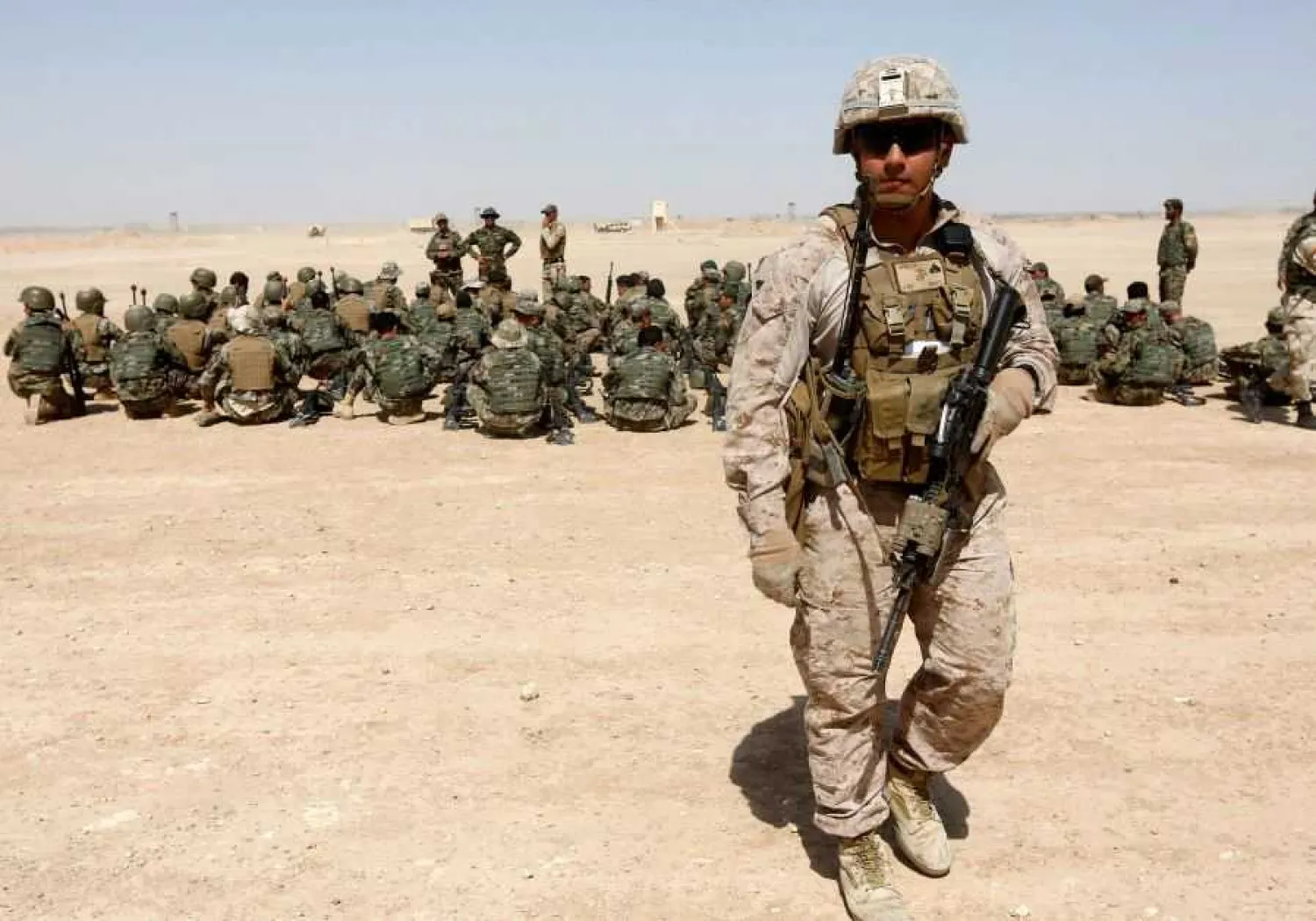 A US Marine walks near Afghan National Army (ANA) soldiers during training in Helmand province, Afghanistan, July 5, 2017. REUTERS/OMAR SOBHANI