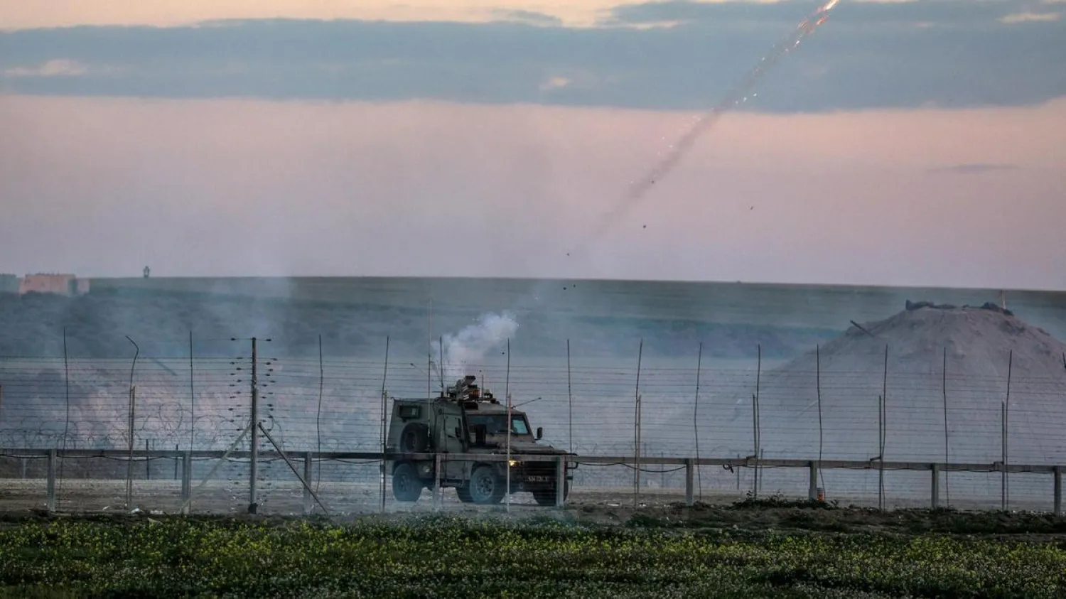 Israeli jeep fires tear-gas during clashes after Friday protests near the border between Israel and Gaza Strip. EPA
