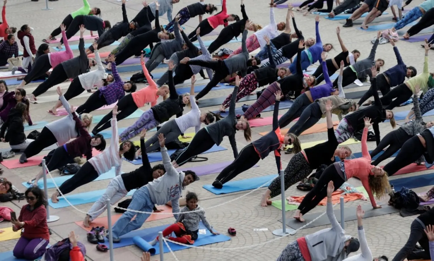Hundreds participate in a mass yoga event in front of the Sydney Opera House on World Yoga Day in Australia. (Reuters)