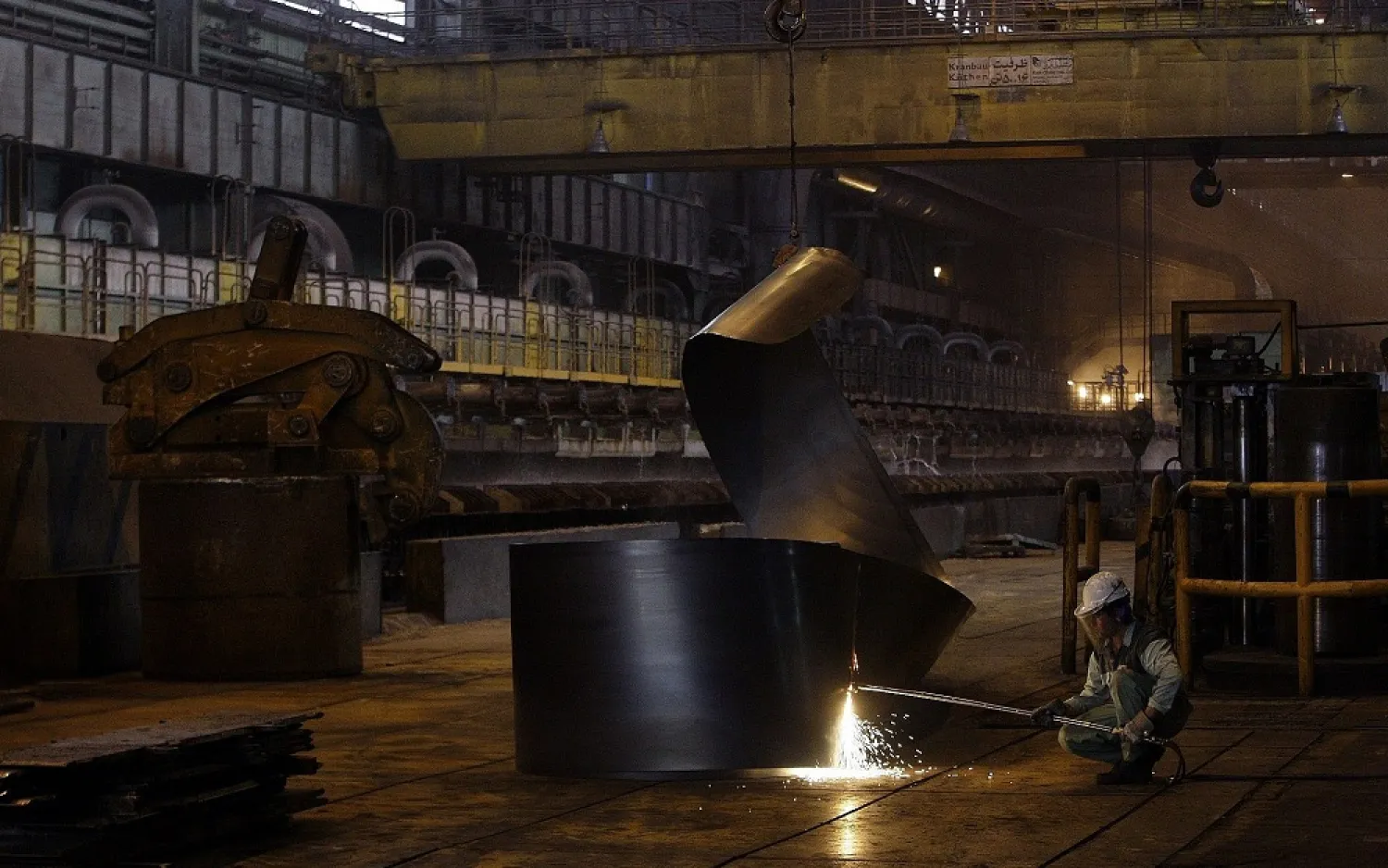 In this photo taken on May 31, 2012, an Iranian worker cuts a steel roll at the Mobarakeh Steel Complex, southwest of central Iranian city of Isfahan. (AP)
