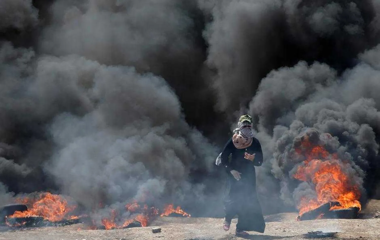 A female Palestinian demonstrator gestures during a protest against US embassy move to Jerusalem and ahead of the 70th anniversary of Nakba, at the Israel-Gaza border, east of Gaza City. Reuters file photo