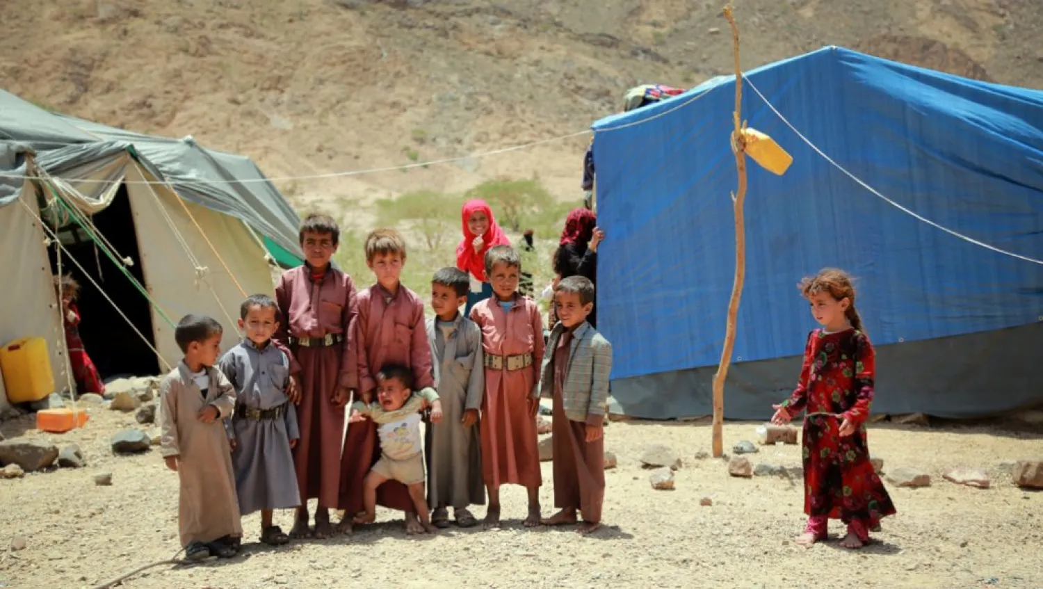 Yemeni children stand outside a tent at a makeshift camp for Internally Displaced Persons. AFP file photo