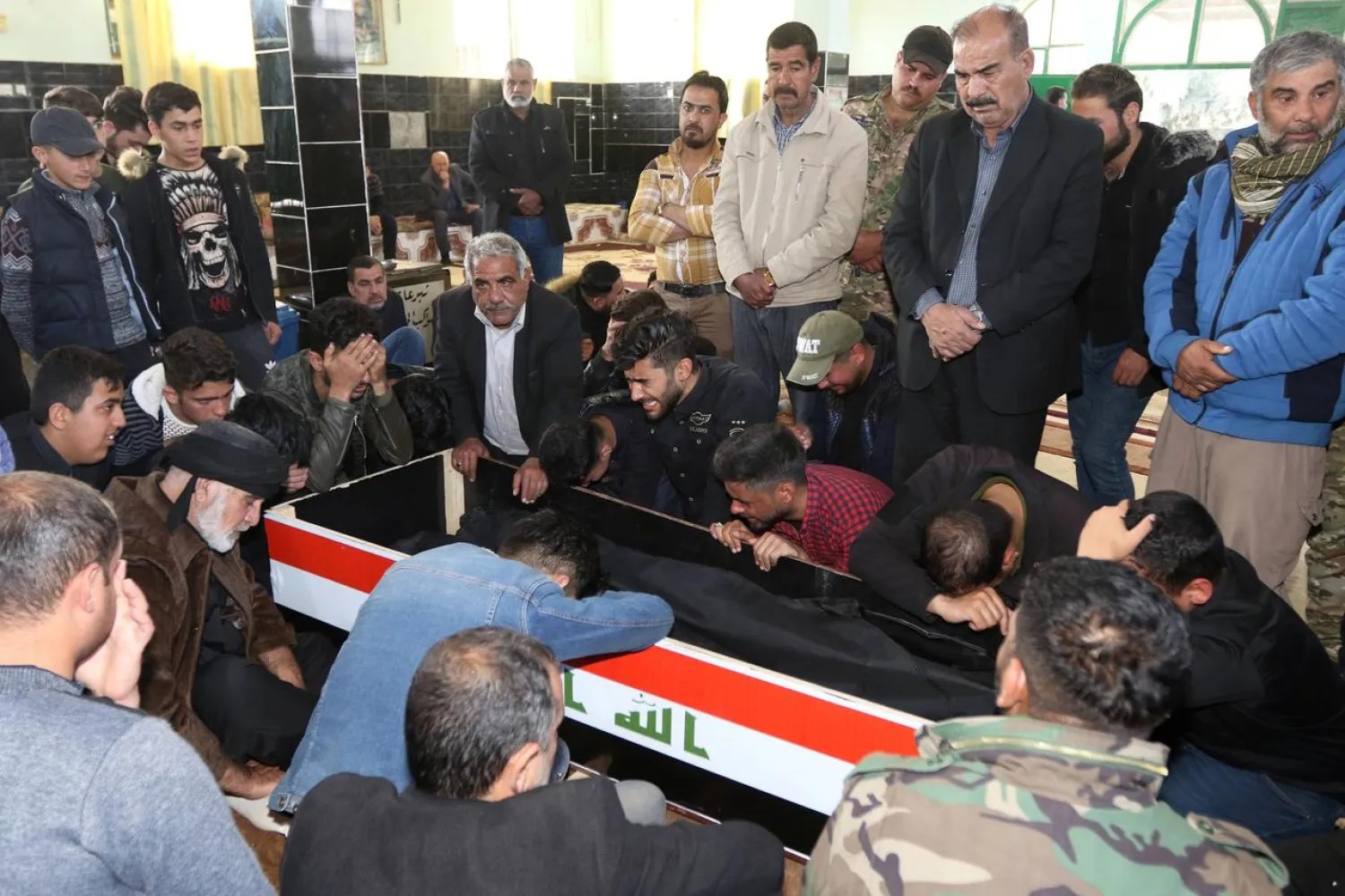Relatives of members of the PMF, who were killed in an ISIS ambush, mourn during the funeral in Tuz Khurmatu, Iraq March 7, 2019. (Reuters)