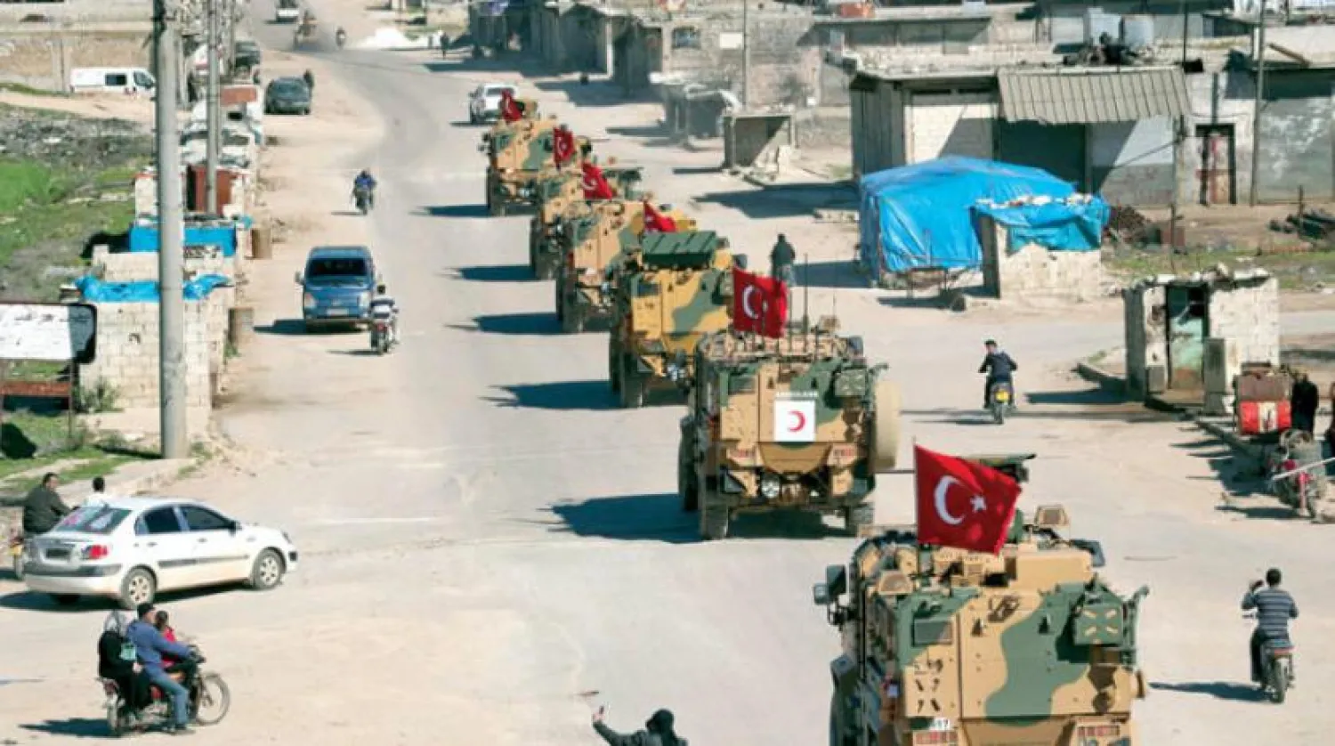 A column of armored Turkish military vehicles drives on a patrol along a road in the de-militarised zone in Syria's northern Idlib province near the town Saraqib on March 8, 2019. OMAR HAJ KADOUR / AFP