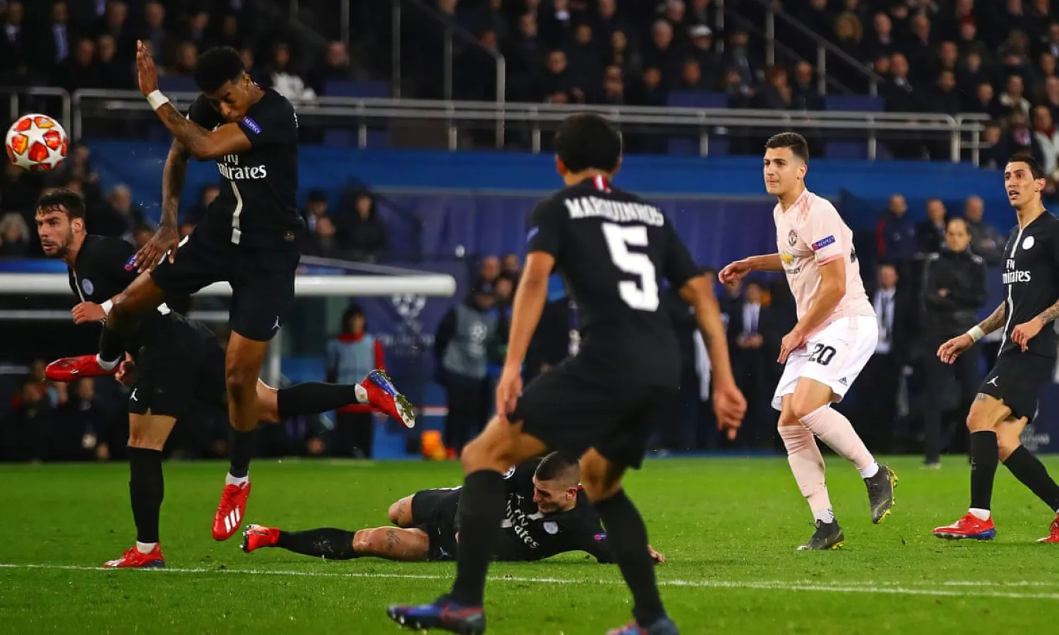 PSG’s Presnel Kimpembe (left) blocks Diogo Dalot’s shot with his hand, leading to the awarding of a controversial penalty by referee Damir Skomina. Photograph: Chris Brunskill/Fantasista/Getty Images