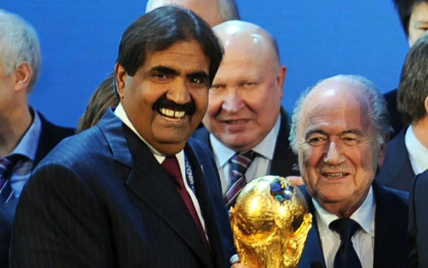 Emir of the State of Qatar Sheikh Hamad bin Khalifa Al-Thani and former Fifa President Joseph Blatter pose with the World Cup following the announcement that Qatar will host 2022 World Cup CREDIT:  PHILIPPE DESMAZES/AFP
