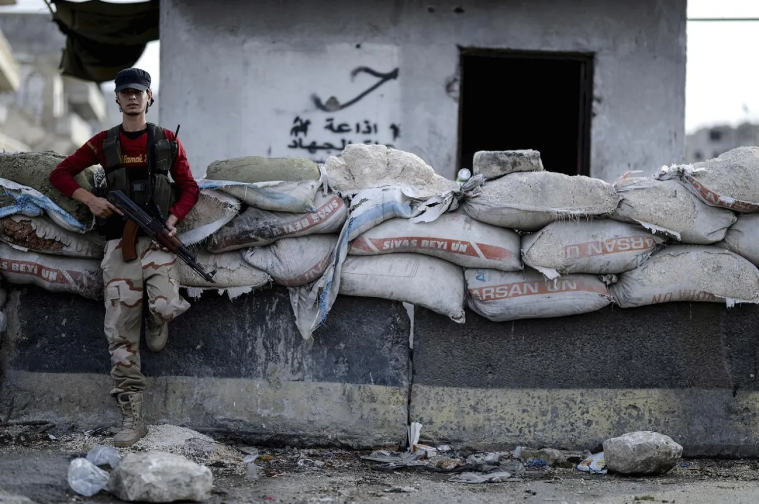  In this Oct. 13, 2018 file photo, a fighter of Syrian opposition stands at a checkpoint in northwestern city of Idlib, Syria. (Ugur Can/DHA via AP, File)