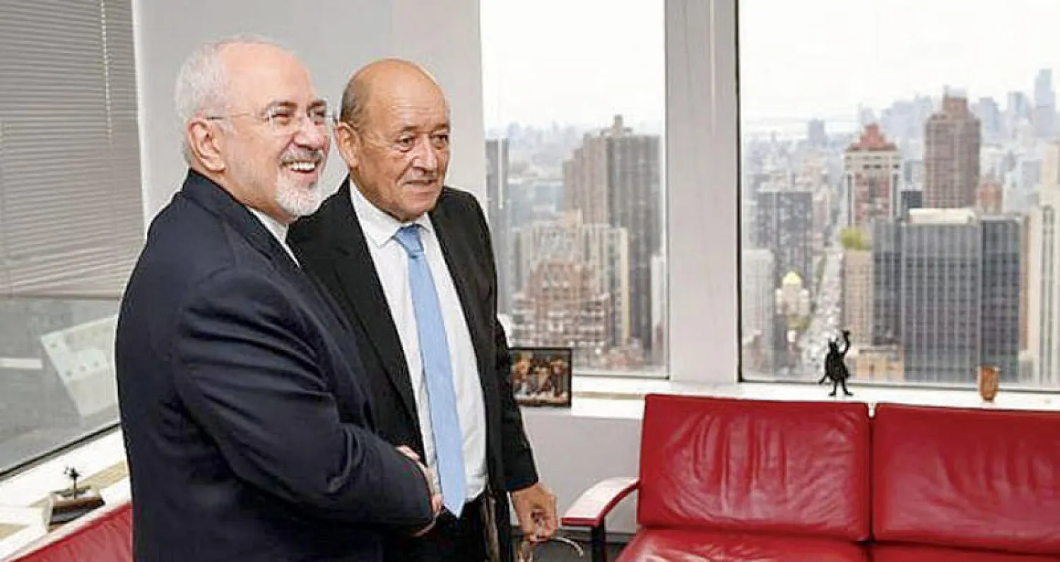 وزير الخارجية الفرنسي  جان إيف لودريان على هامش مباحثات مع نظيره الإيراني (أ.ف.ب)