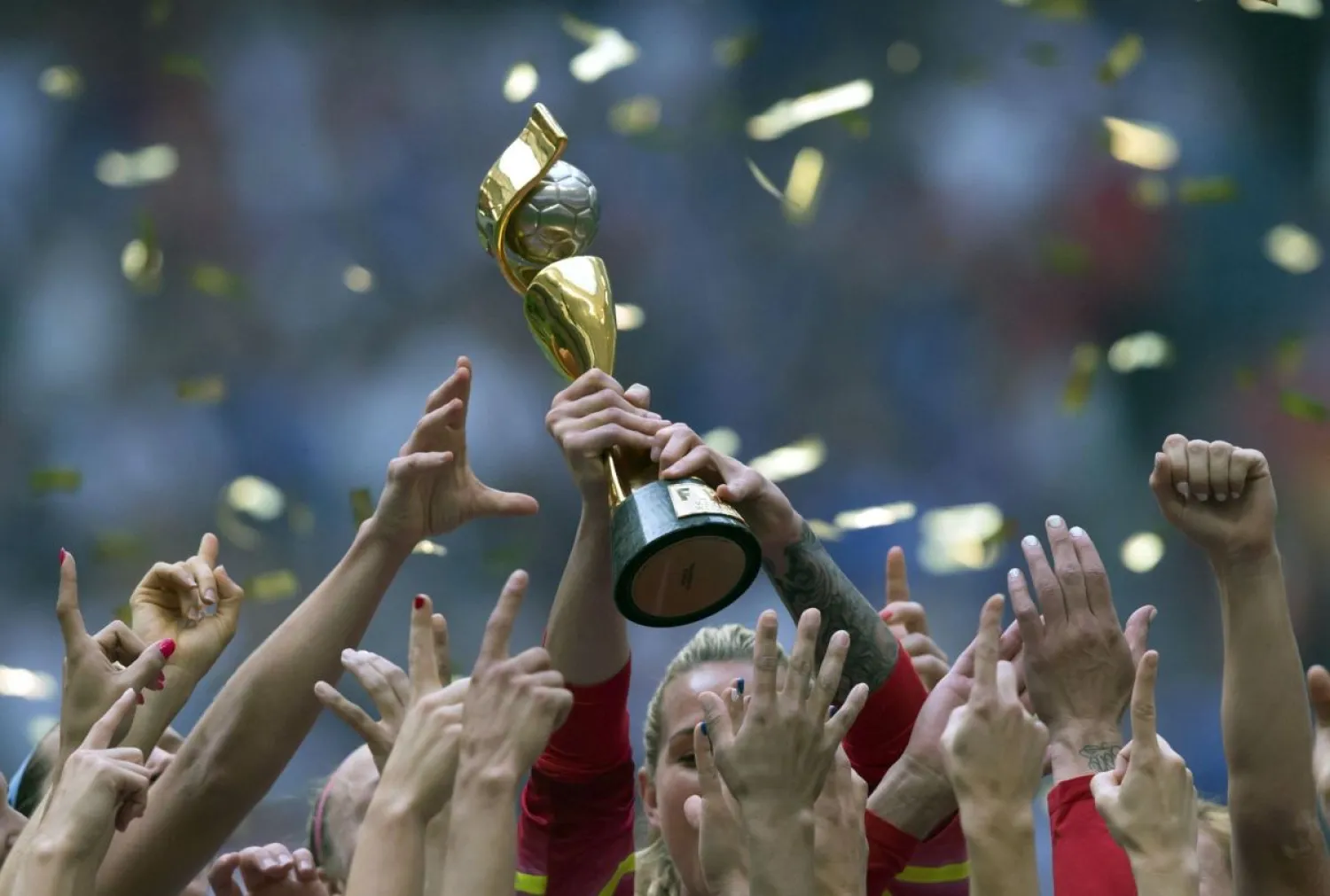 In this July 5, 2015, file photo, the United States Women's National Team celebrates with the trophy after they defeated Japan 5-2 in the FIFA Women's World Cup soccer championship in Vancouver, British Columbia, Canada. (Darryl Dyck/The Canadian Press via AP, File)