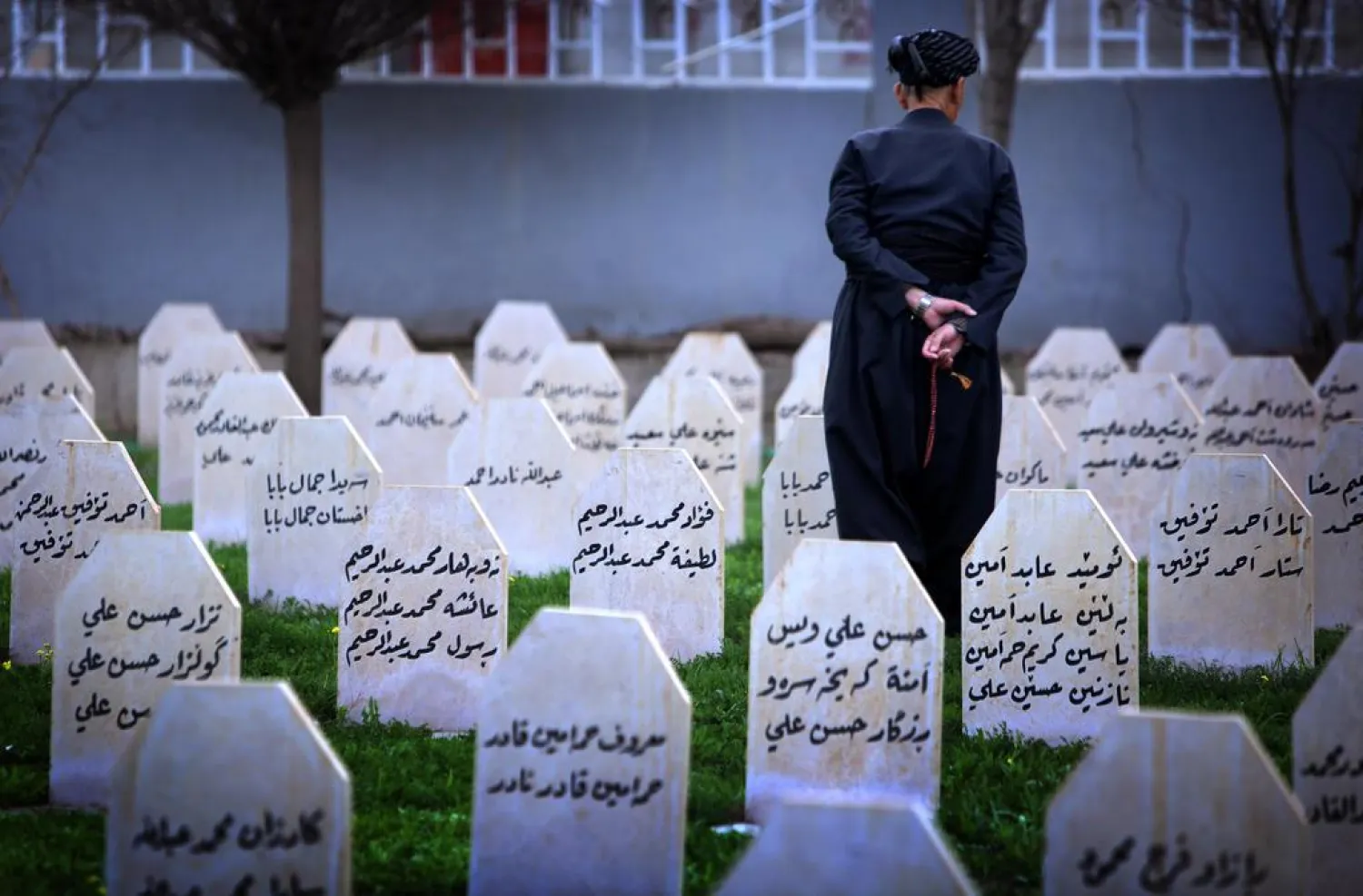 An Iraqi Kurd man visits a graveyard and a monument for the victims who were killed in the 1988 Halabja attack. (AFP)