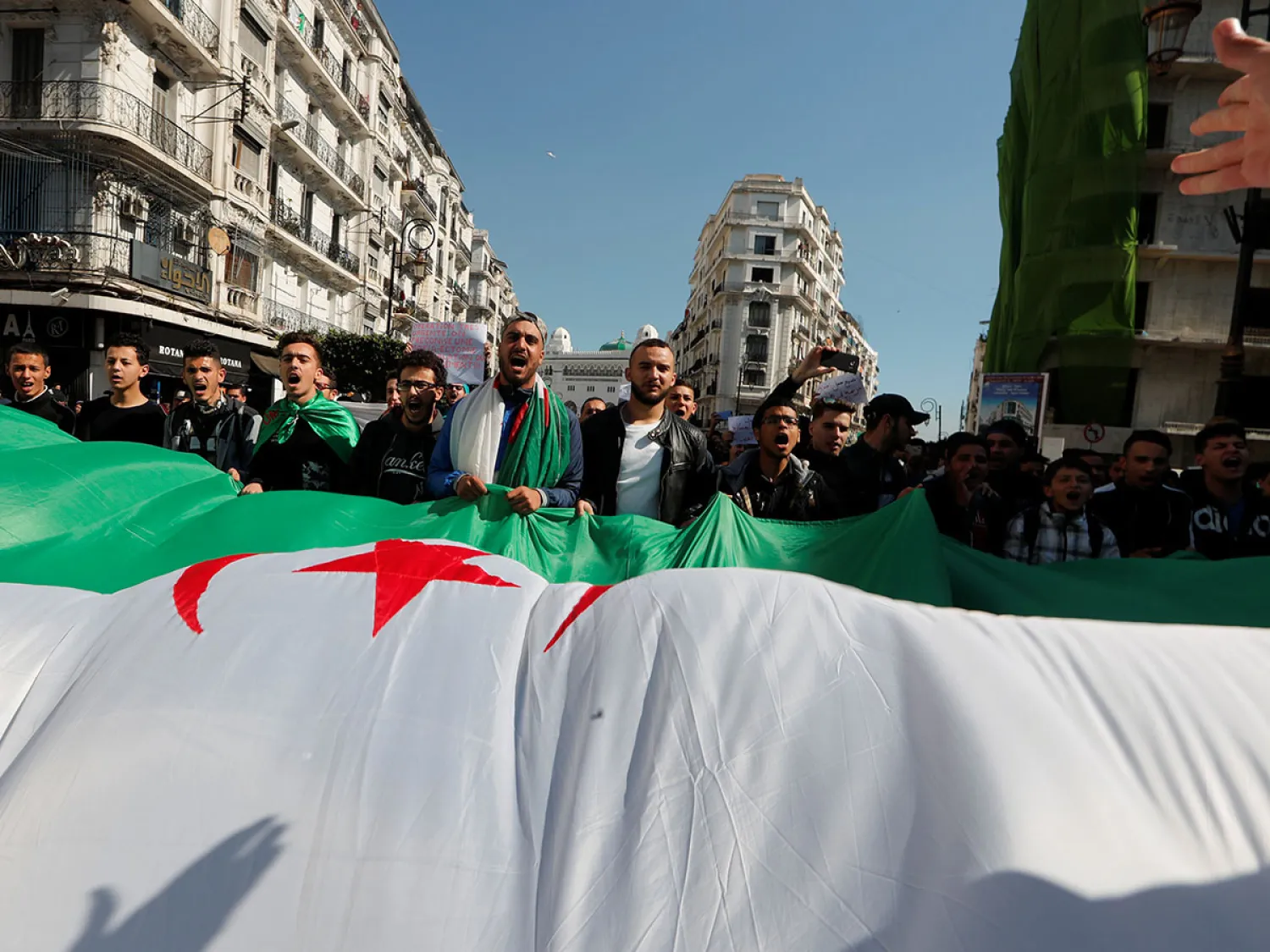 People take part in a protest demanding immediate political change in Algiers. (Reuters)
