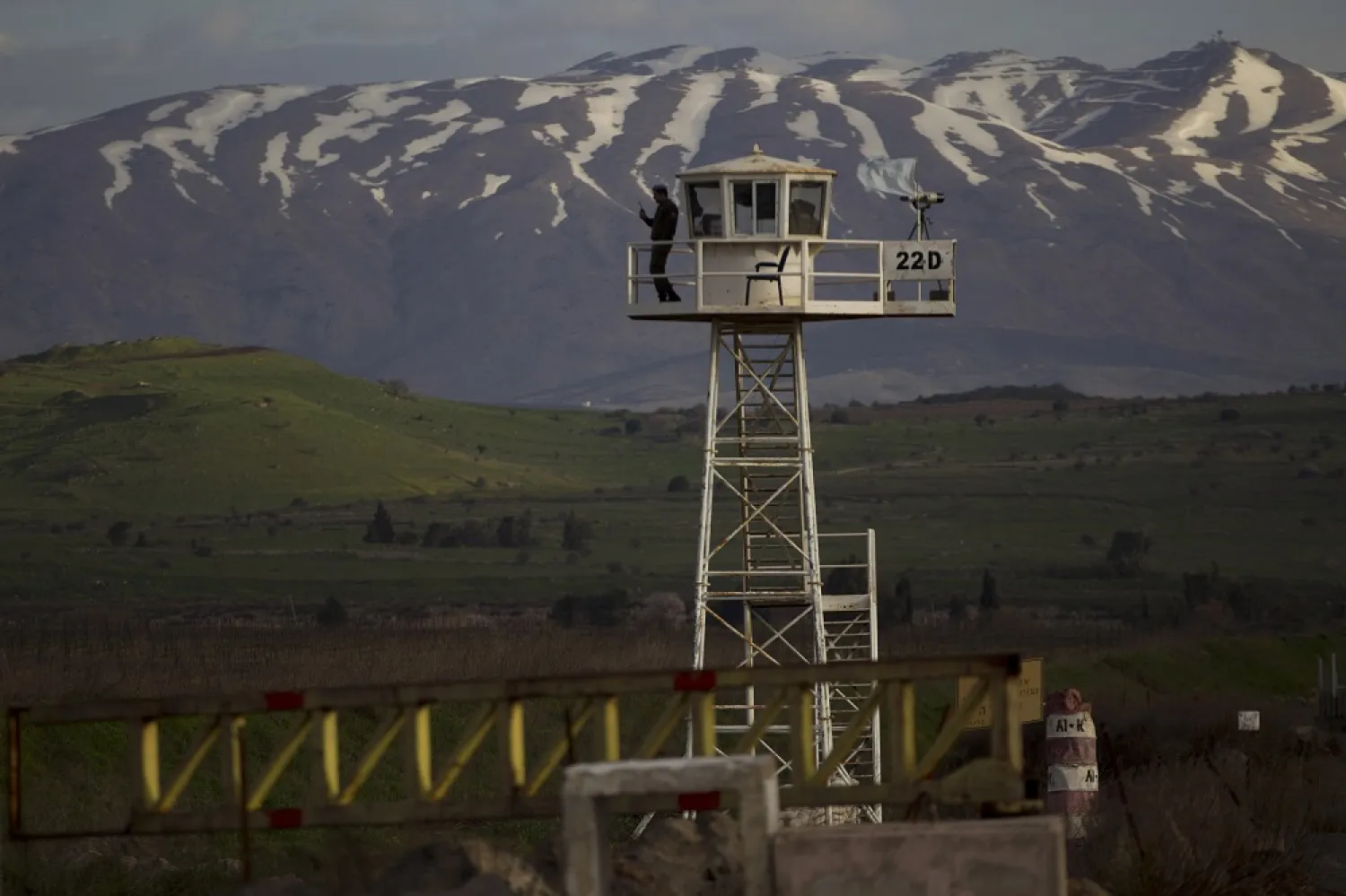 In this March 8, 2013, file photo, a UN peacekeeper stands guard on a watch tower at the Quneitra crossing between Syria and the Israeli-occupied Golan Heights. (AP)