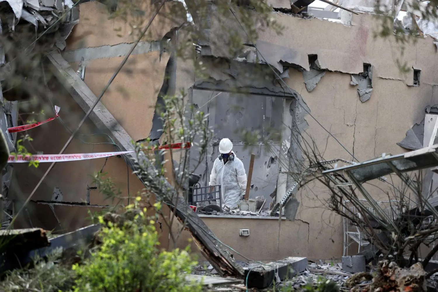 A police sapper inspects a damaged house that was hit by a rocket north of Tel Aviv Israel March 25, 2019. REUTERS/ Ammar Awad