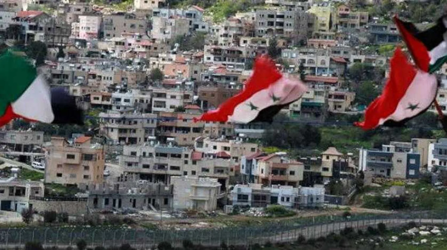 Syrian flags are seen in the village of Ain el-Tineh in the Golan Heights. AFP file photo